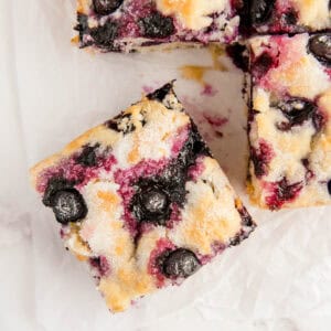 Close-up of blueberry breakfast cake with a golden sugar top and baked fresh blueberries.