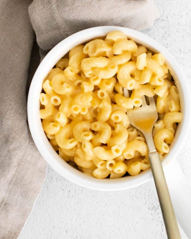 a white bowl filled with creamy mac and cheese