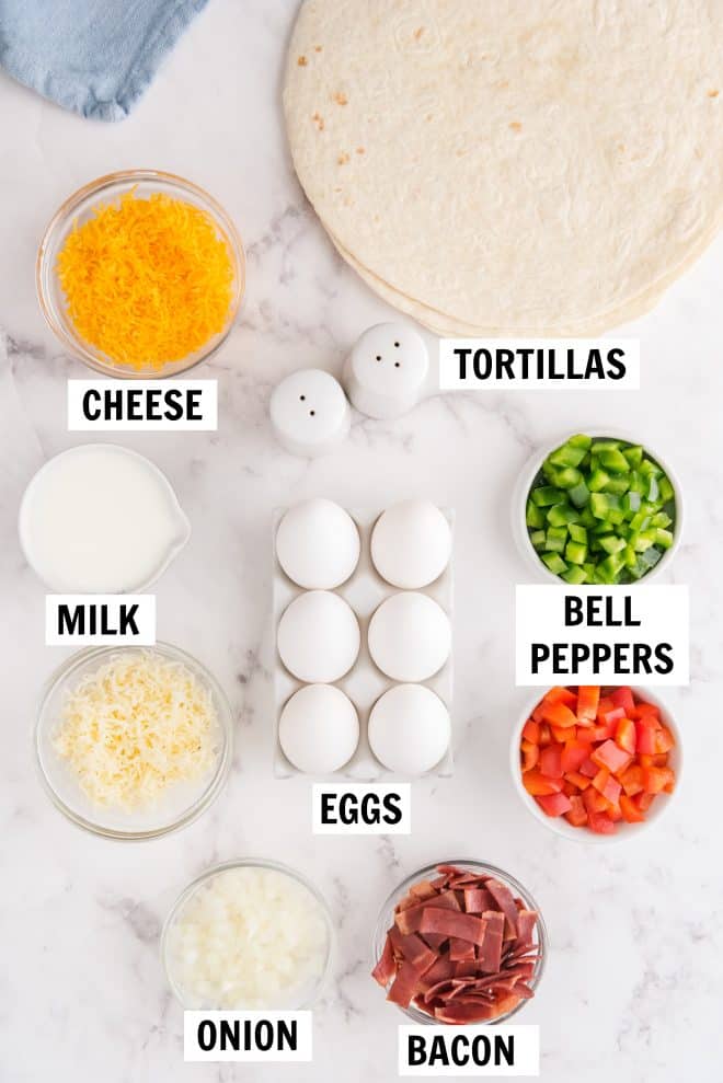 ingredients for breakfast burrito on white countertop