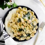 a plate with whipped ricotta and pasta with kale