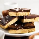a stack of four buckeye bars sitting on a white plate