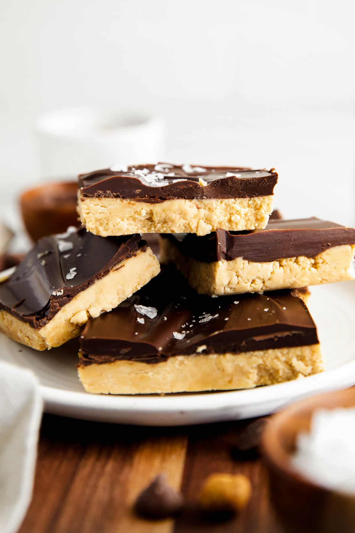 a stack of four buckeye bars sitting on a white plate