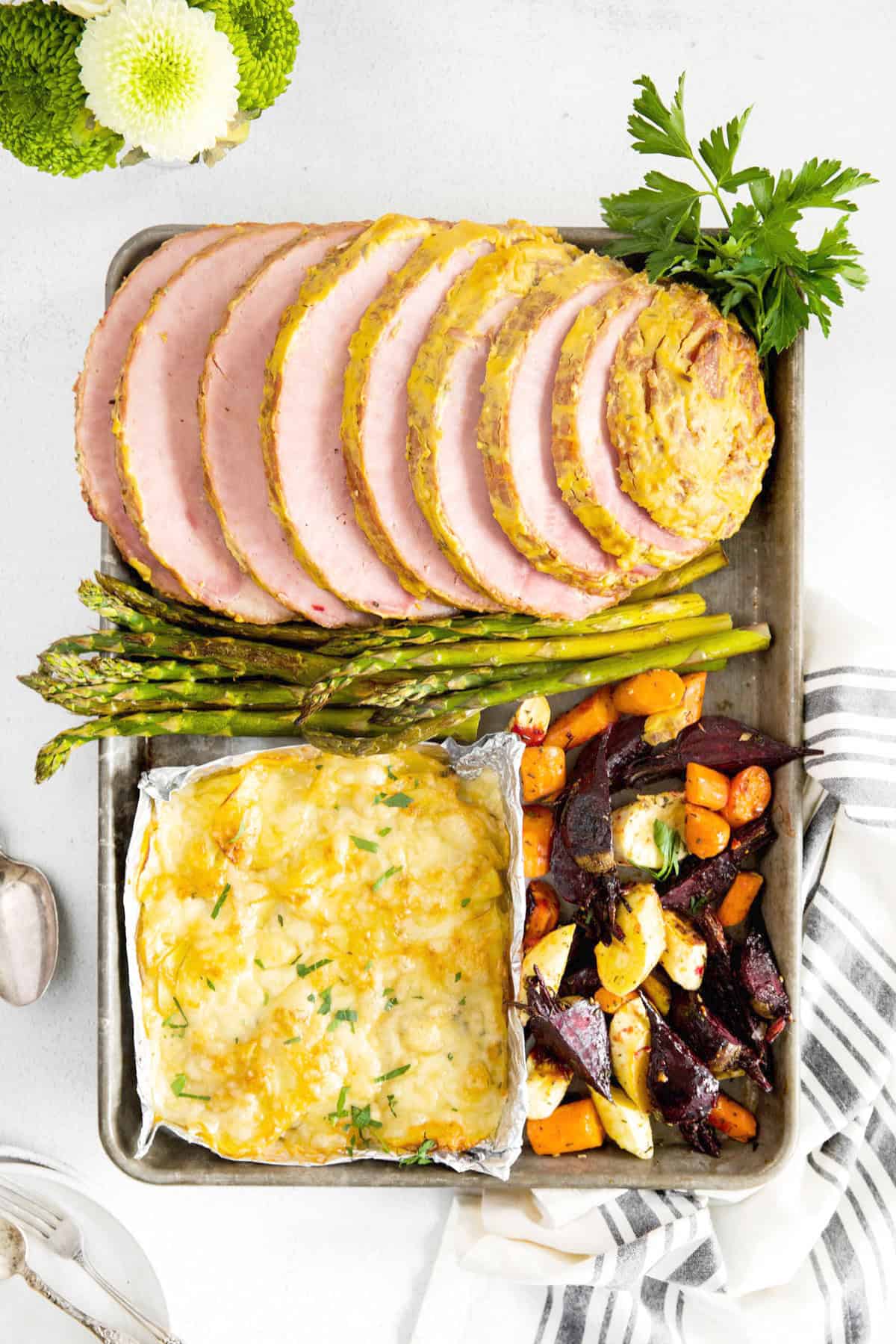 easter ham dinner on a sheet pan after baking
