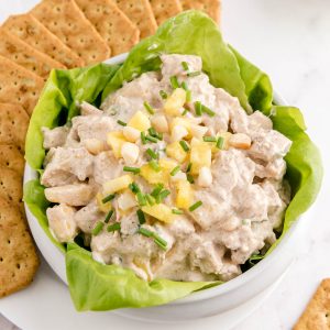 a bowl filled with hawaiian chicken salad with crackers