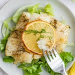crispy air fryer lemon cod on a plate with a fork