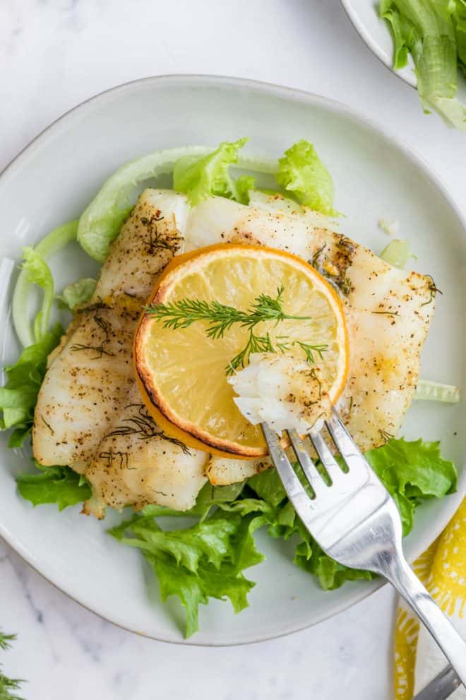 crispy air fryer lemon cod on a plate with a fork