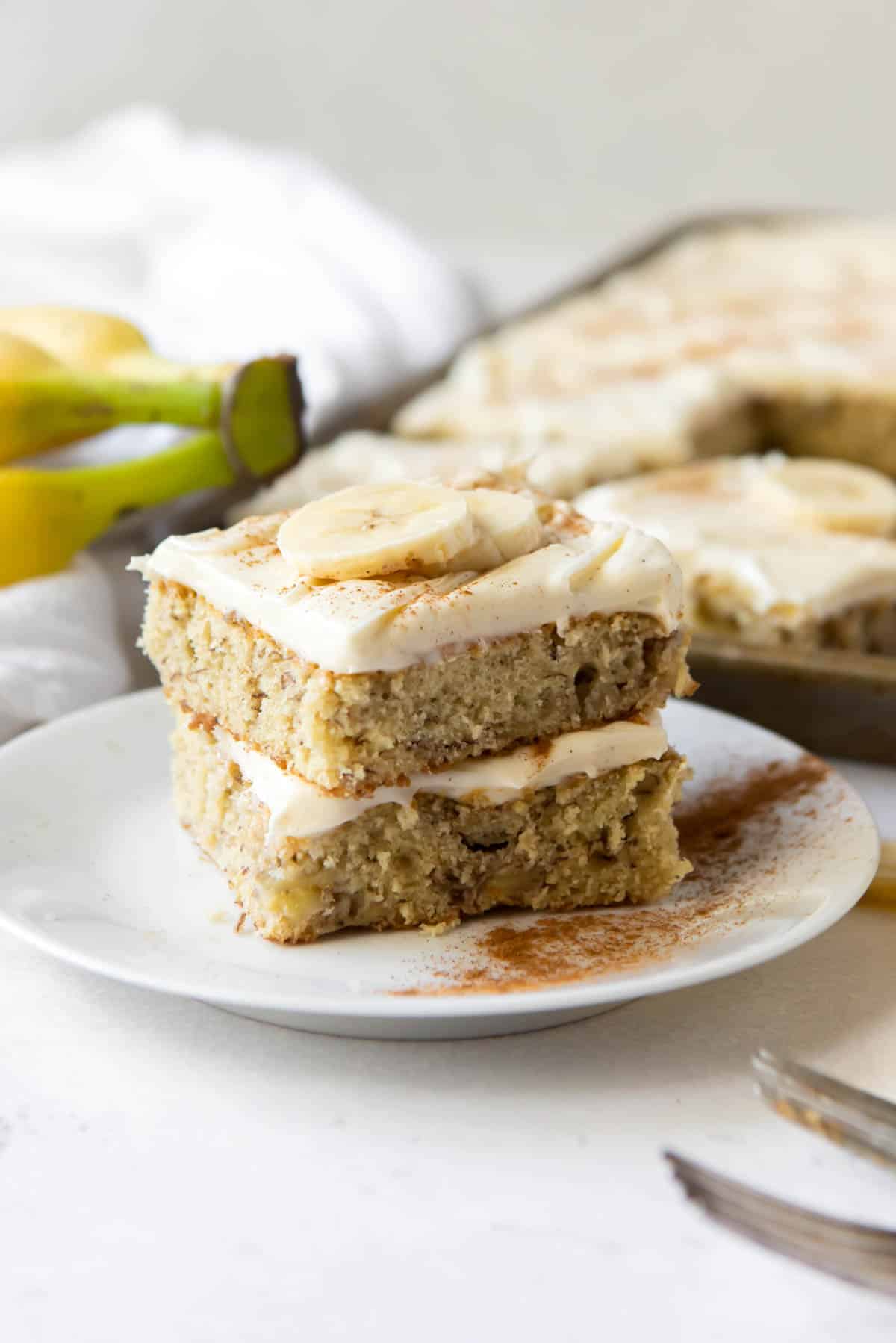 Two banana bars stacked on top of each other on a white plate