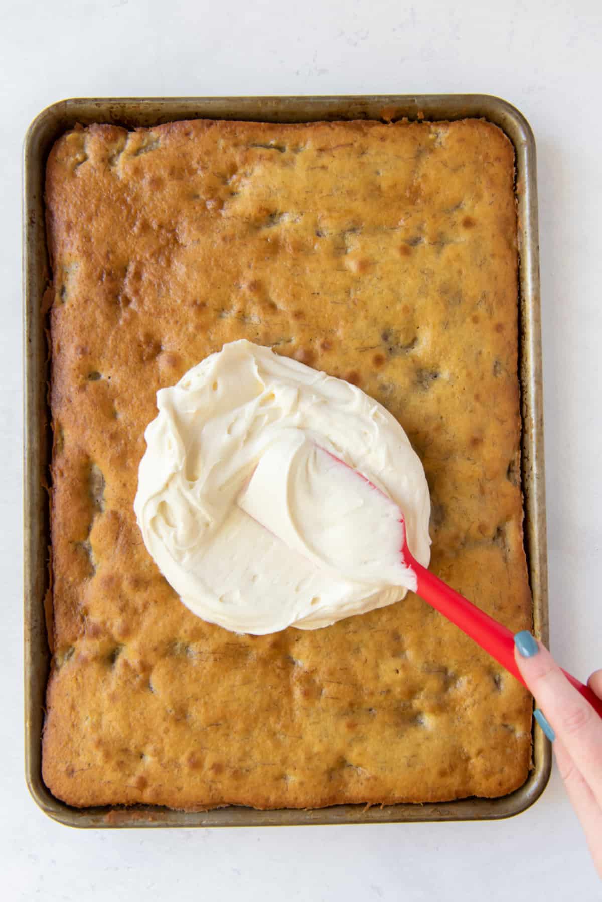 spreading frosting on banana bars