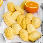 baked citrus madeleines sitting on a piece of parchment paper