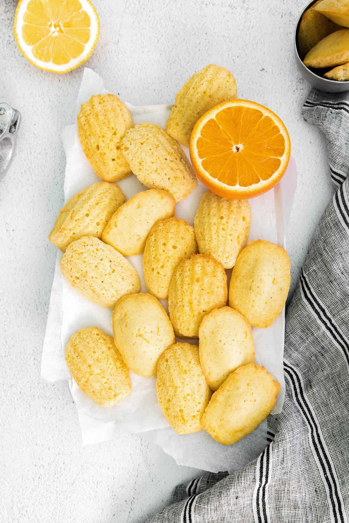 homemade citrus madeleine cookies on a piece of parchment paper