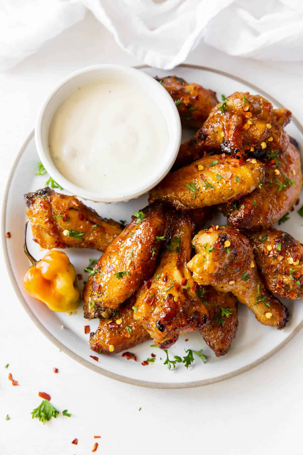 Aerial view of a plate of wings with a dish of blue cheese