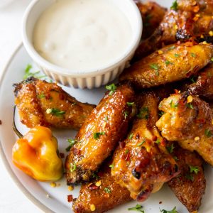 A plate of wings with a dish of blue cheese