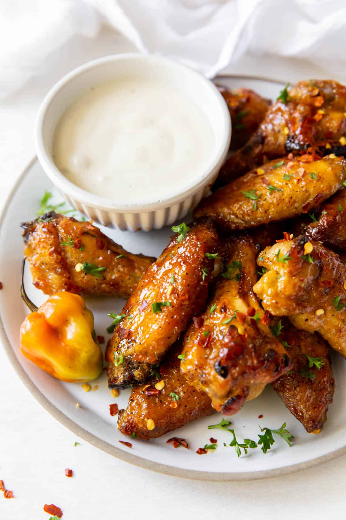 A plate of wings with a dish of blue cheese