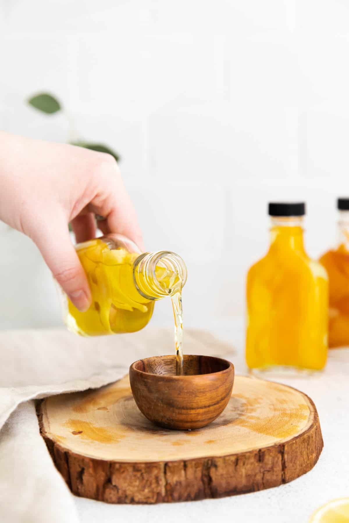 pouring a small amount of lemon extract into a bowl