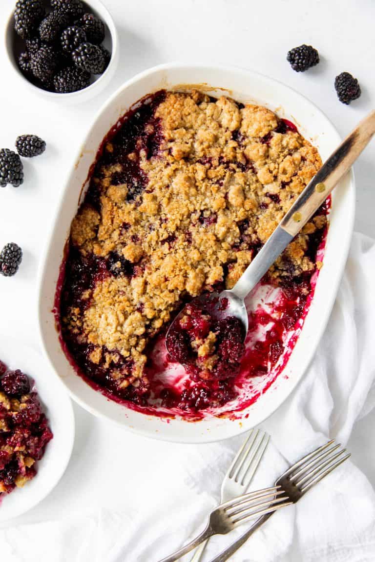 baked blackberry cobbler in white baking dish