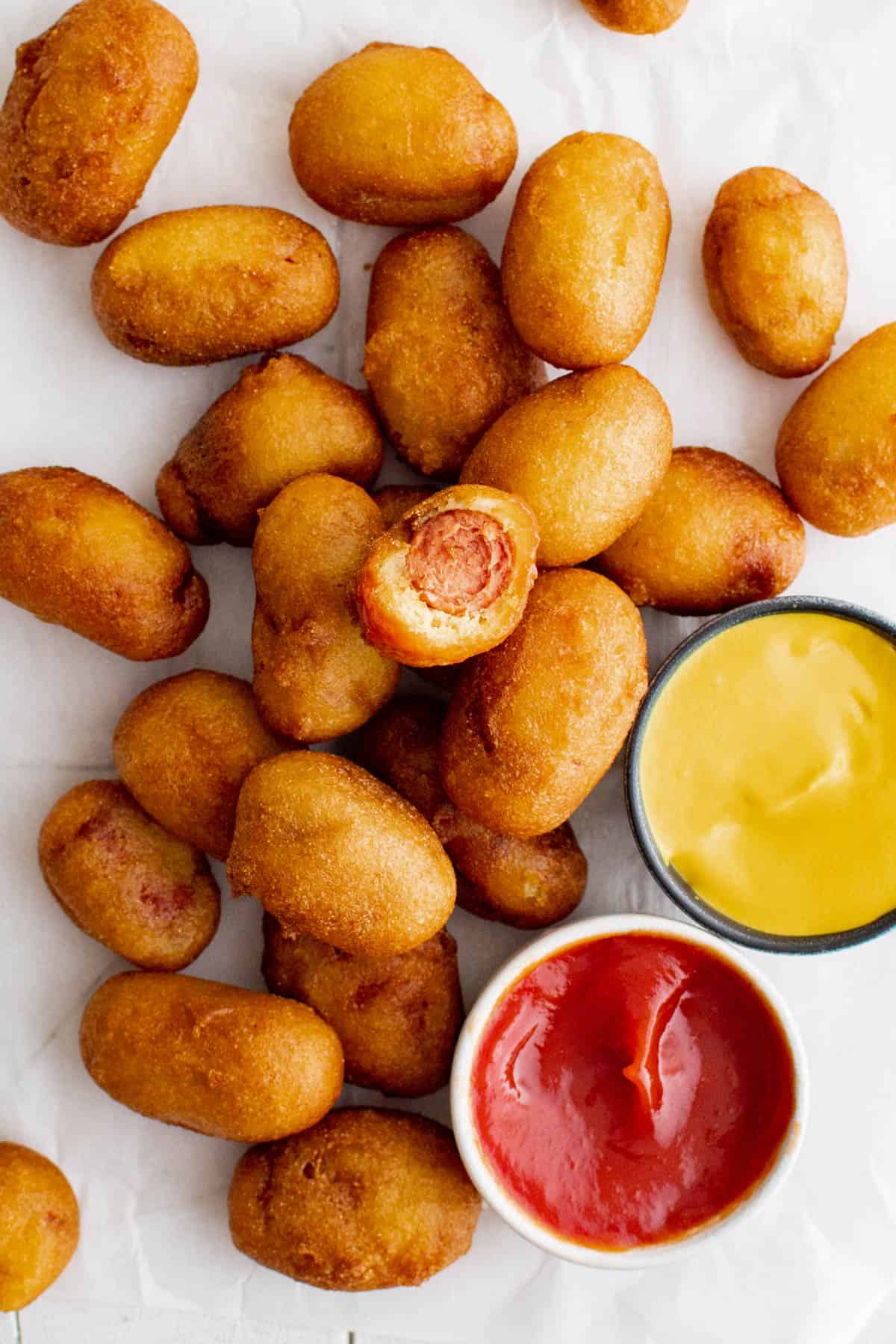 mini corn dogs on a white piece of parchment paper