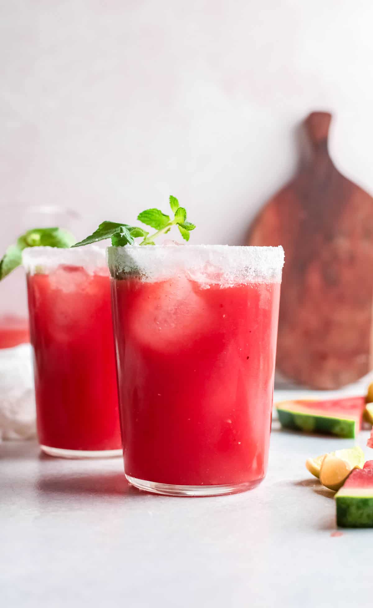 two watermelon paloma drinks on a tabletop