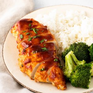 air fryer bbq chicken on a plate with rice and broccoli