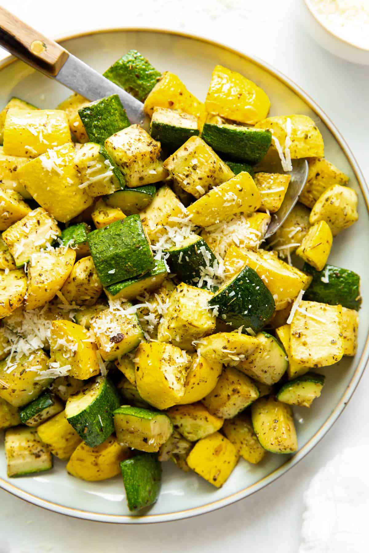 baked zucchini and squash sprinkled with parmesan cheese