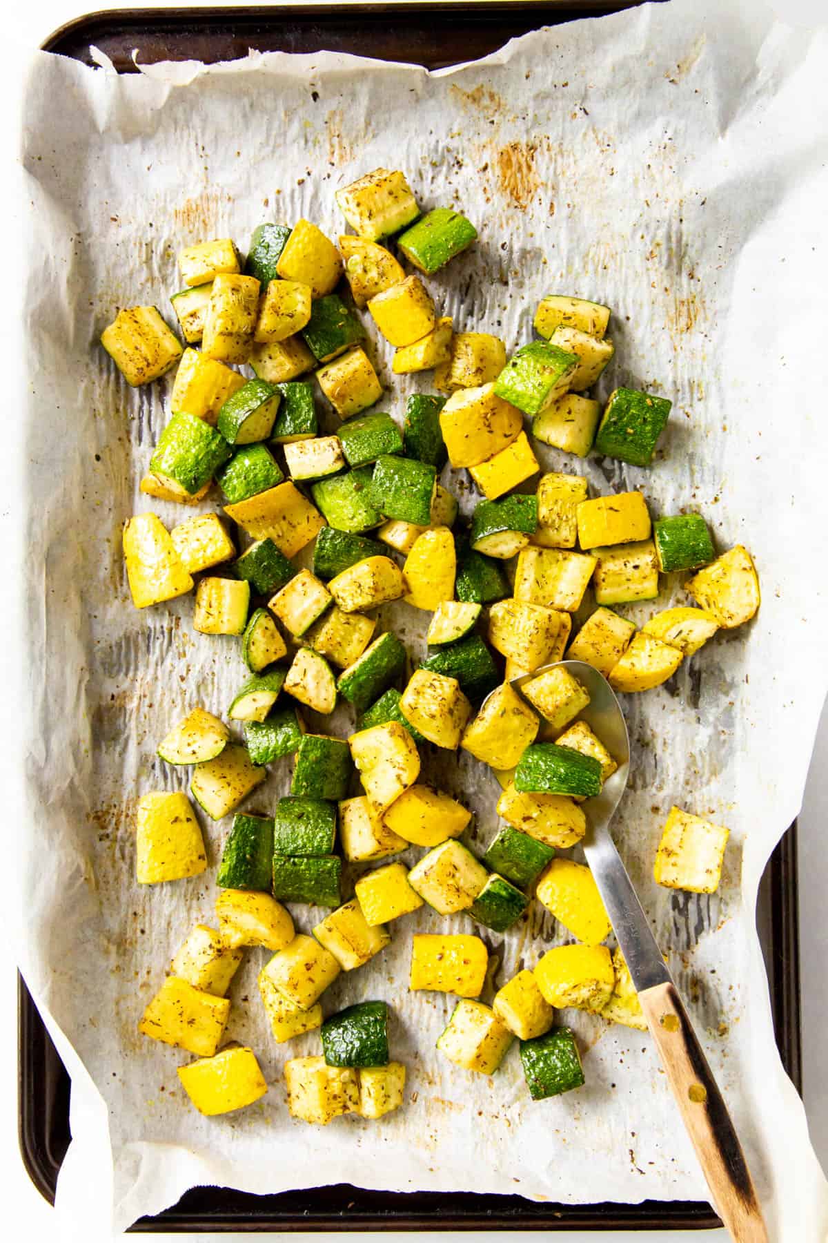 zucchini and squash pieces on a sheet pan after baking