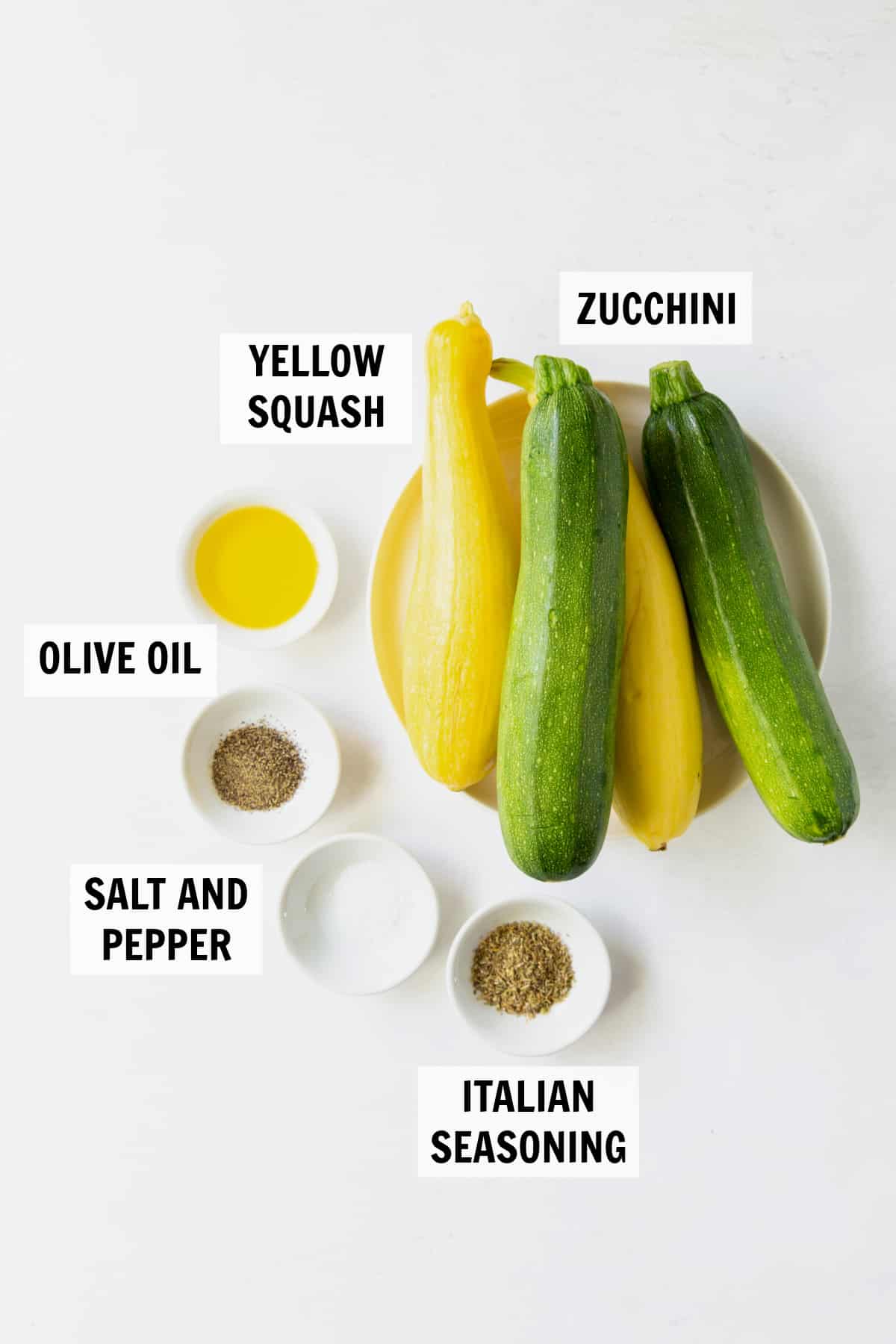 ingredients for baked zucchini and squash on a white tabletop