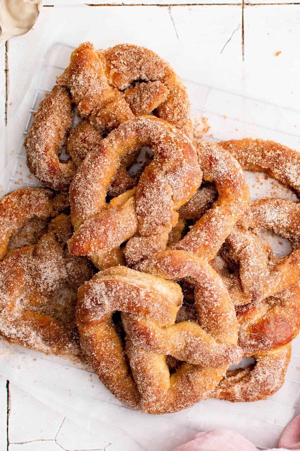 a stack of cream cheese stuffed pretzels on a piece of parchment paper