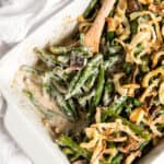 fresh green bean casserole with onion strings in a white rectangular casserole dish