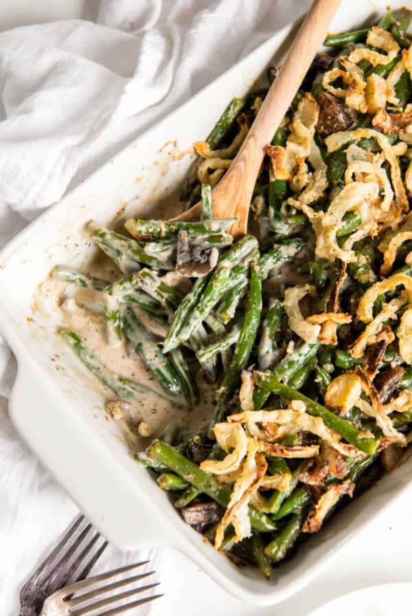 fresh green bean casserole with onion strings in a white rectangular casserole dish
