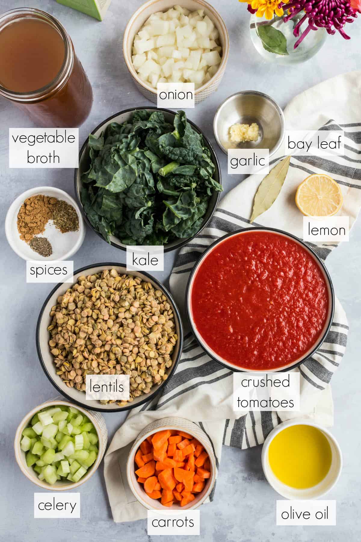 all of the ingredients for lentil and kale soup on a tabletop