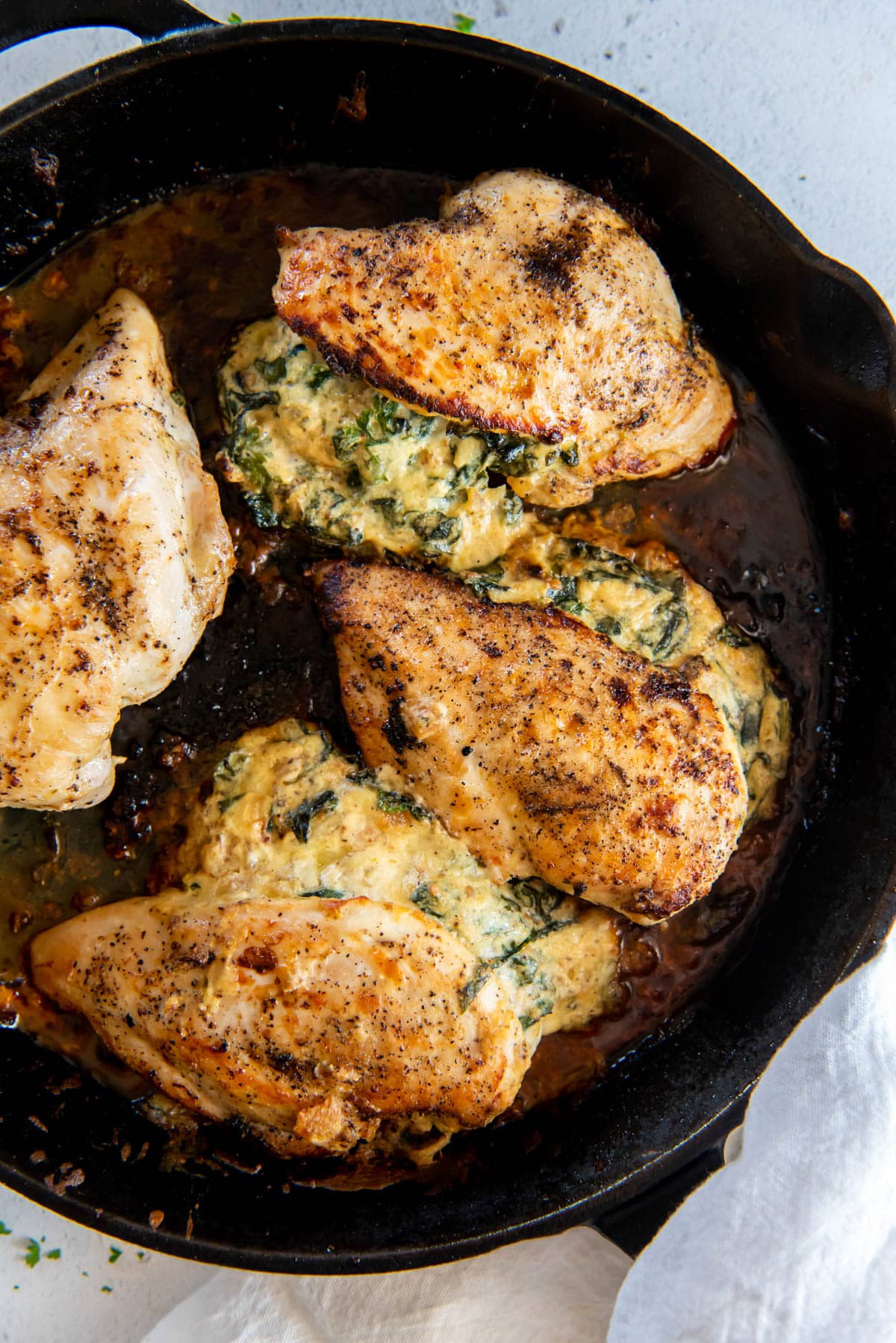 spinach ricotta stuffed chicken in a black skillet