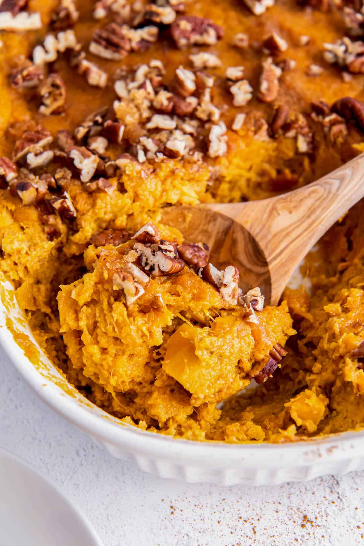 a spoon scooping out sweet potato souffle