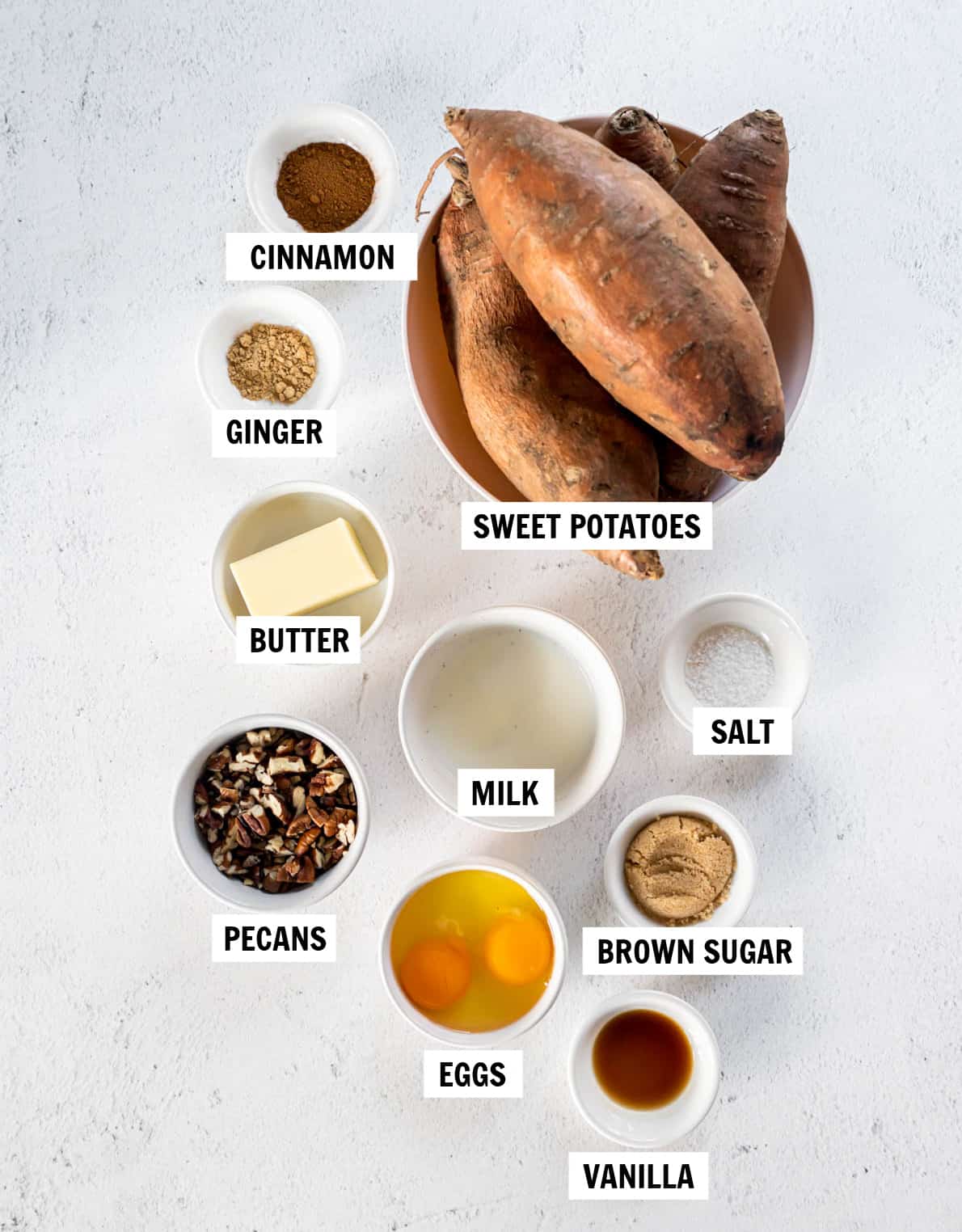 all of the ingredients for sweet potatoes on a white countertop