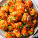 buffalo cauliflower bites piled high on a plate