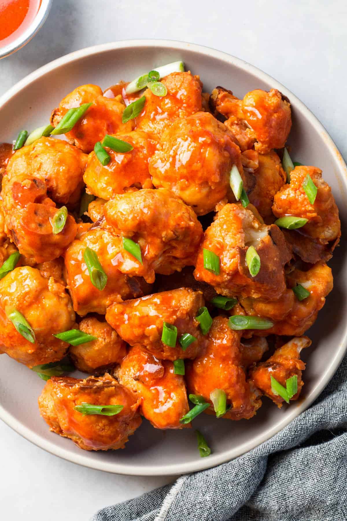 buffalo cauliflower bites piled high on a plate