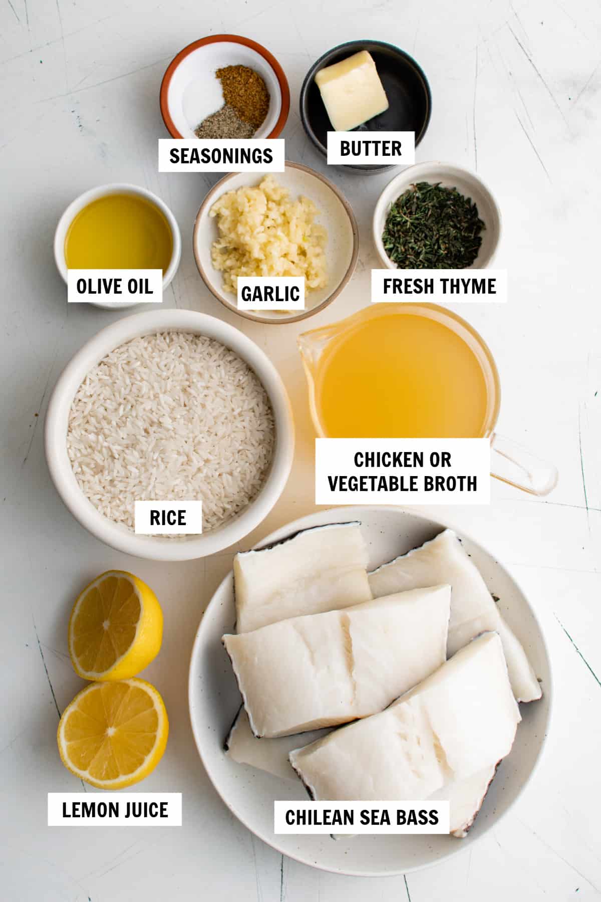 all of the ingredients for chilean seas bass on a white countertop