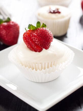 one angel food cupcake with strawberry filling sitting on a white square plate