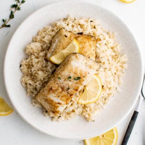 a plate with garlic and herb rice and chilean sea bass