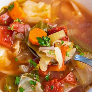 cabbage soup in a bowl with parsley garnish on top
