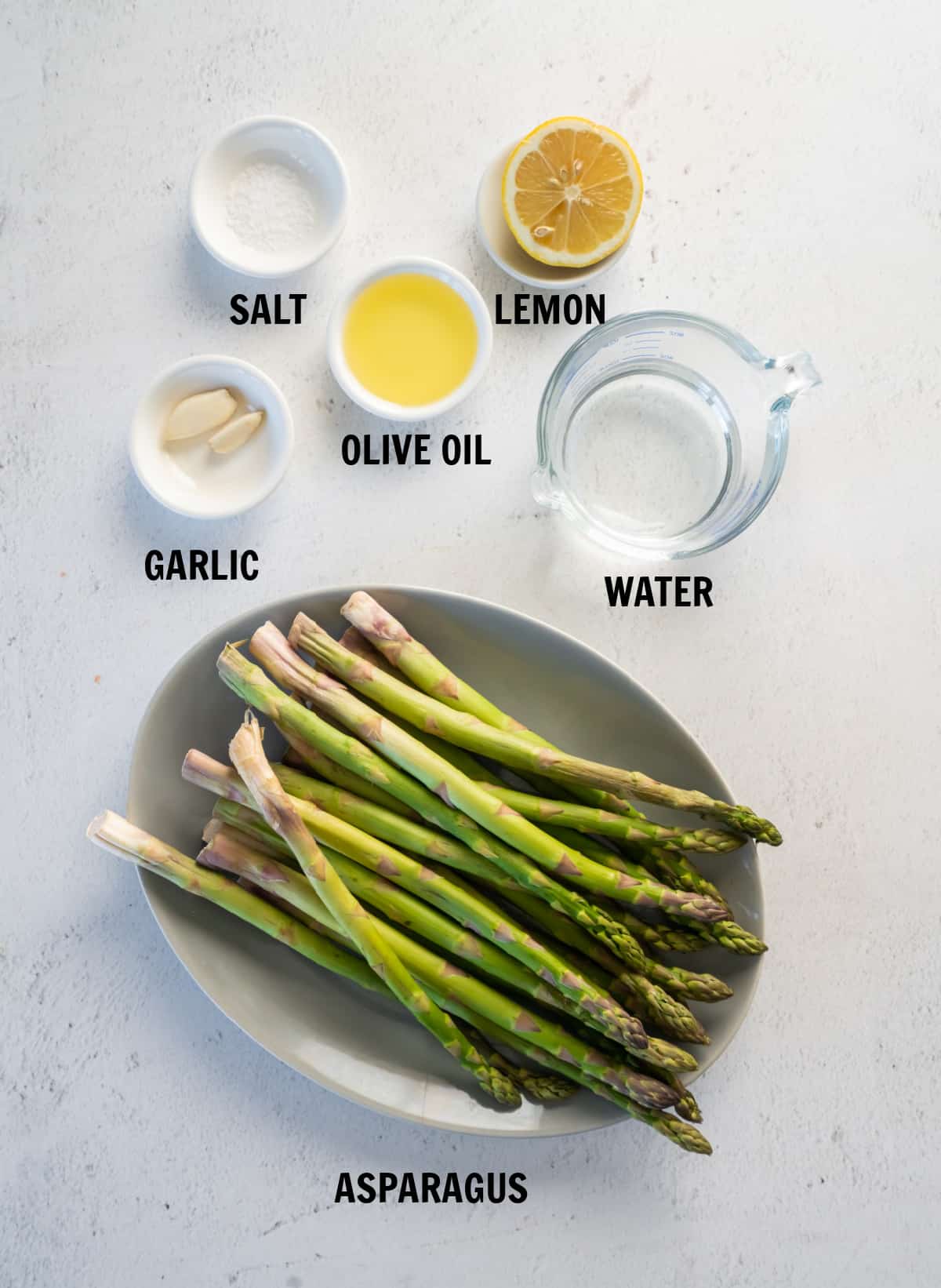 all of the ingredients for instant pot asparagus on a white countertop