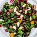 sauteed swiss chard on a plate with sliced almonds on top