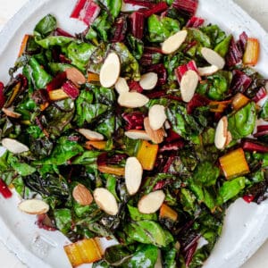 sauteed swiss chard on a plate with sliced almonds on top