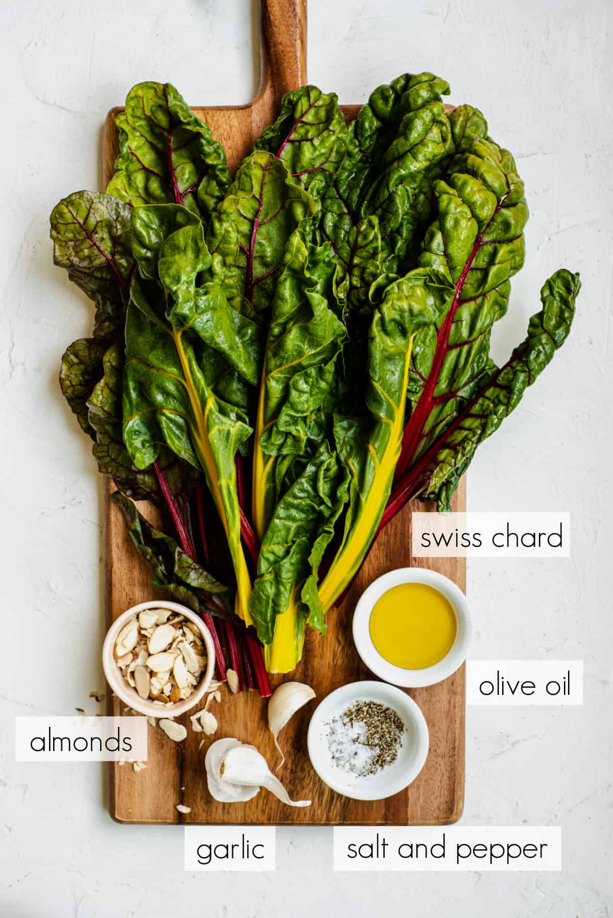 all of the ingredients for swiss chard on a white countertop