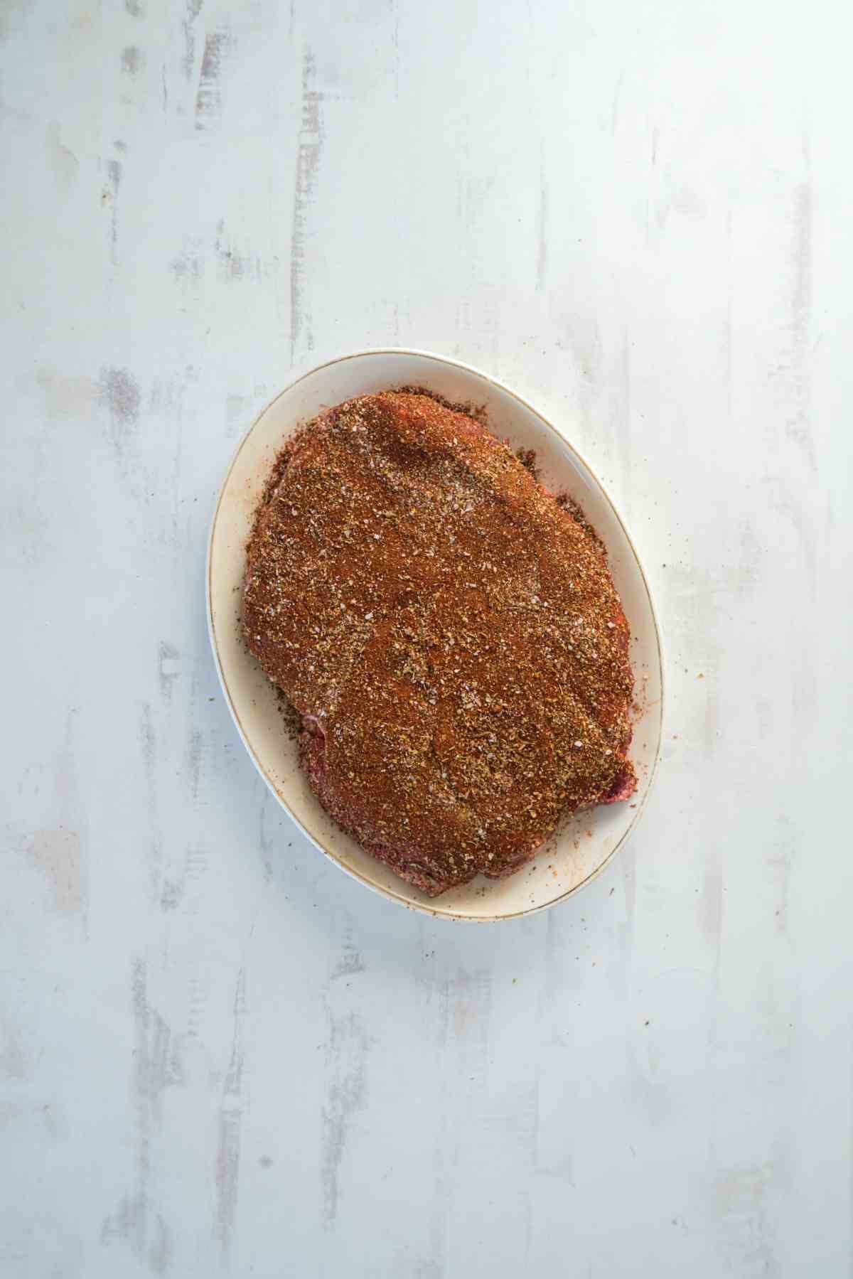Chuck roast coated with chili powder, cumin, paprika, oregano, salt, and pepper before cooking in the Instant Pot.