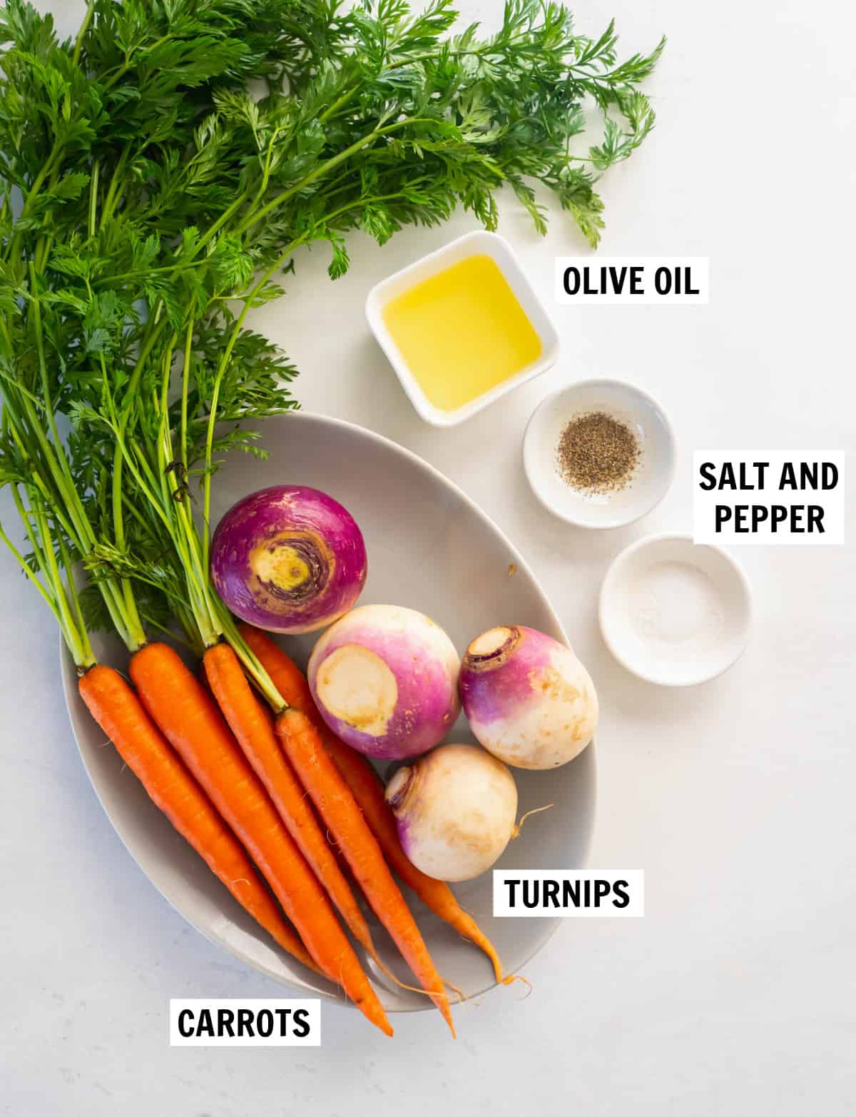 all of the ingredients for roasted turnips and carrots on a white tabletop