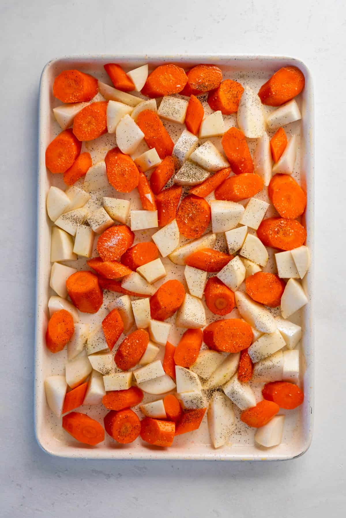 cut carrots and turnips on a sheet pan with olive oil, salt and pepper