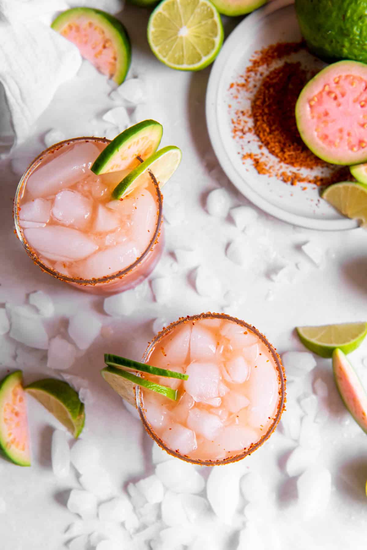 Two guava margaritas sitting on a white counter.