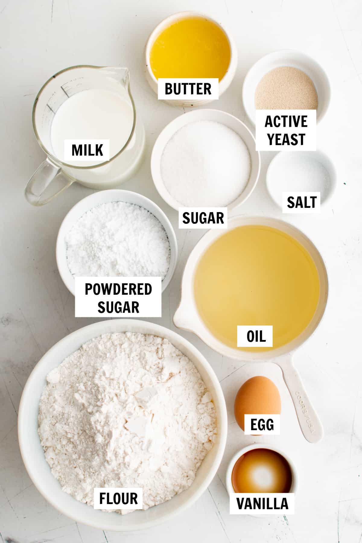 All of the ingredients for princess and the frog beignets on a white countertop.