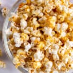 A large clear bowl filled with sweet and salty popcorn.