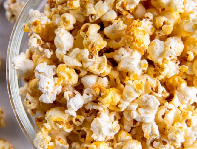 A large clear bowl filled with sweet and salty popcorn.