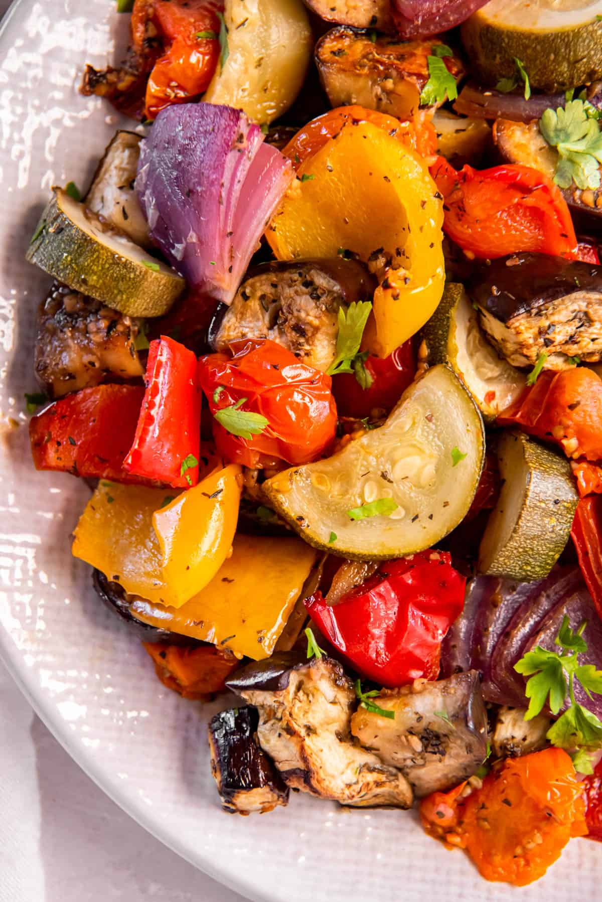 A plate filled with Mediterranean Roasted Vegetables for serving.